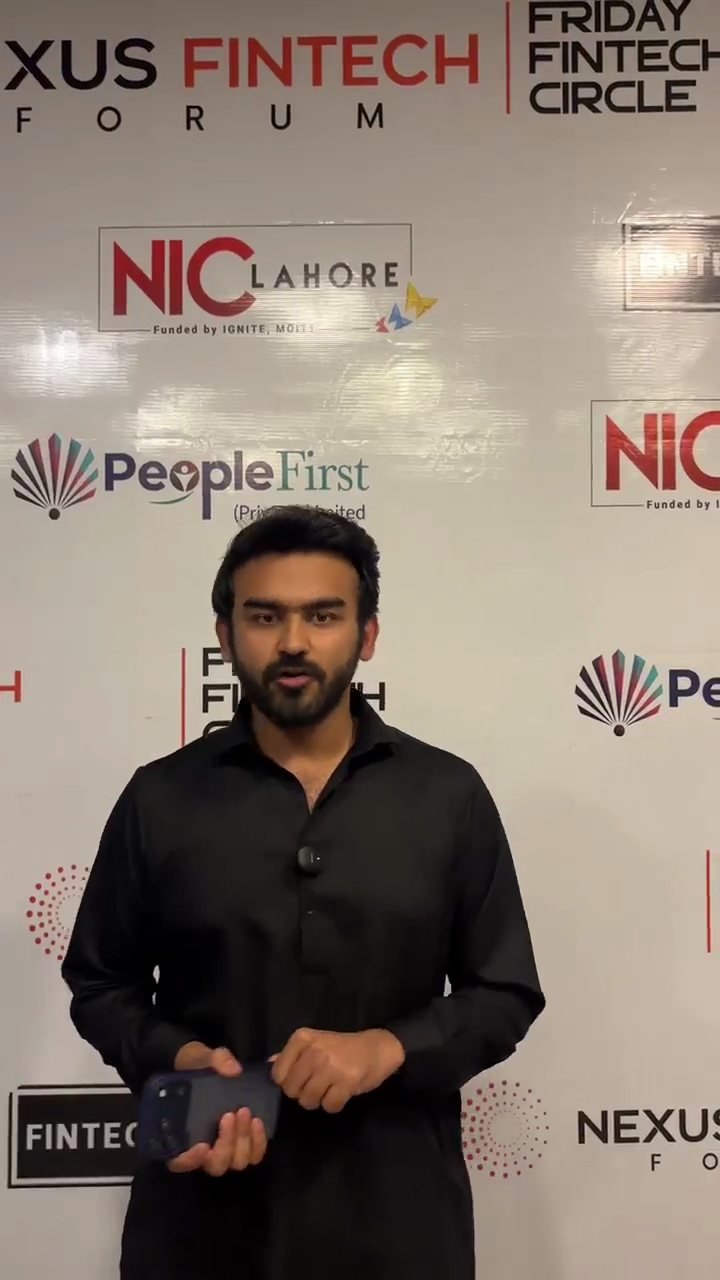 Bassam Siddiqui speaking to camera in front of the Nexus Fintech Forum and Friday Fintech Circle backdrop